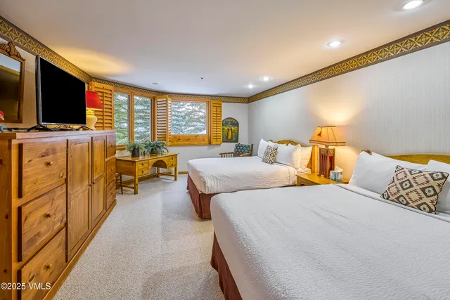 a bedroom with double bed and a flat screen tv