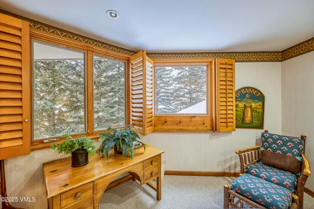 a living room with furniture and a floor to ceiling window