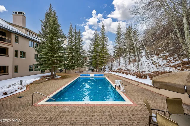 a view of a swimming pool with a yard