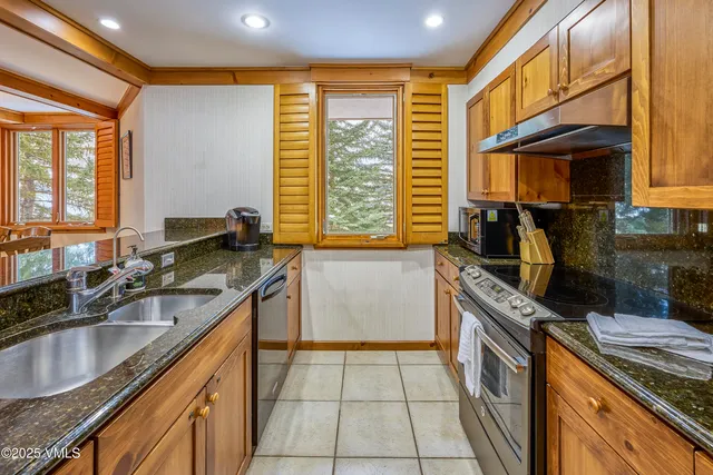 a kitchen that has a sink and a stove in it