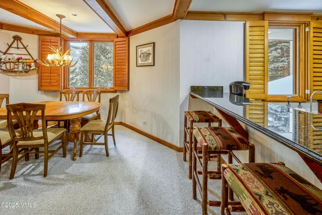 a view of a dining room with furniture and window