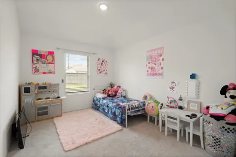 a living room with furniture a baby crib and a couch