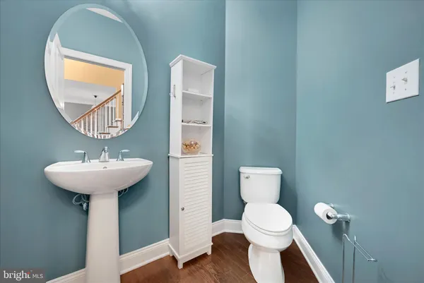 a bathroom with a toilet a sink and a mirror