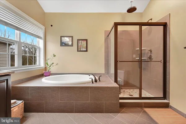 a bathroom with a tub and a mirror