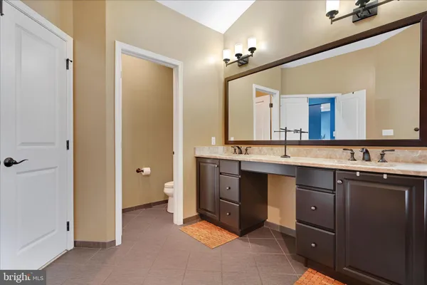 a spacious bathroom with a double vanity sink a and mirror