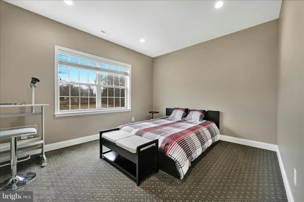 a bed sitting in a room next to a window