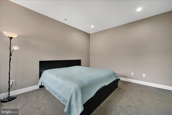 a bedroom with a bed and lamp