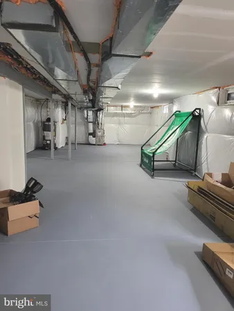 a room with gym equipment and a chandelier
