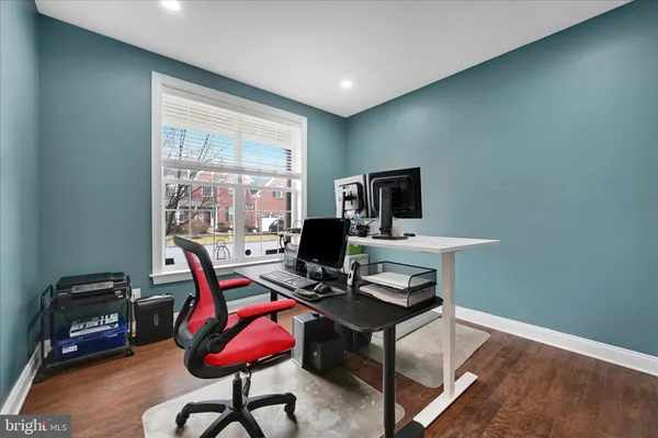a view of a workspace with furniture and a window
