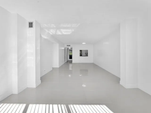 a view of an empty room and a windows