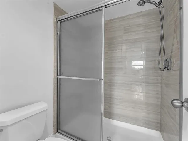 a bathroom with a shower and toilet