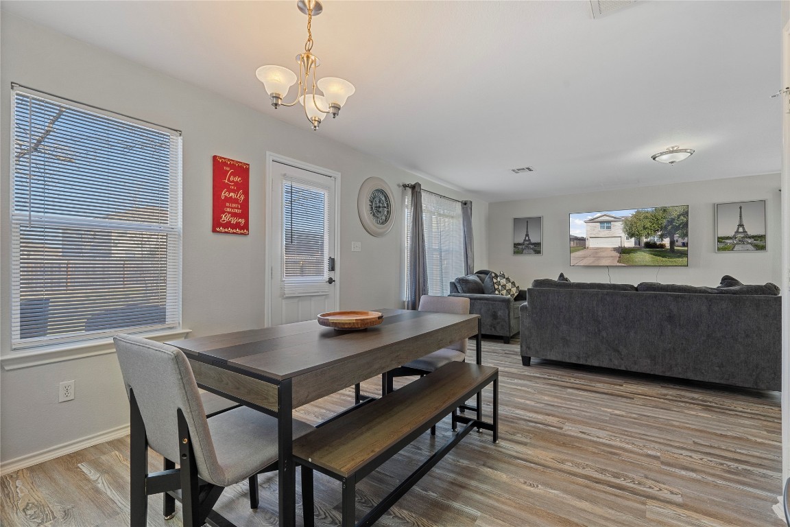 202 Rinehardt Street Hutto, TX 78634 - Photo 13 of 31 a view of a dining room with furniture and wooden floor