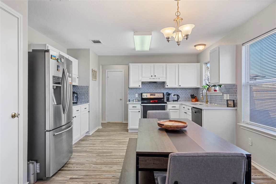 202 Rinehardt Street Hutto, TX 78634 - Photo 16 of 31 a kitchen with refrigerator and cabinets