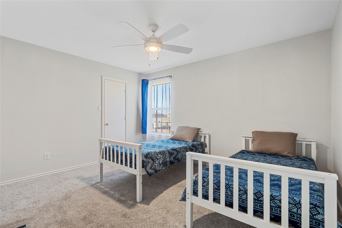 202 Rinehardt Street Hutto, TX 78634 - Photo 23 of 31 a bedroom with furniture and a window