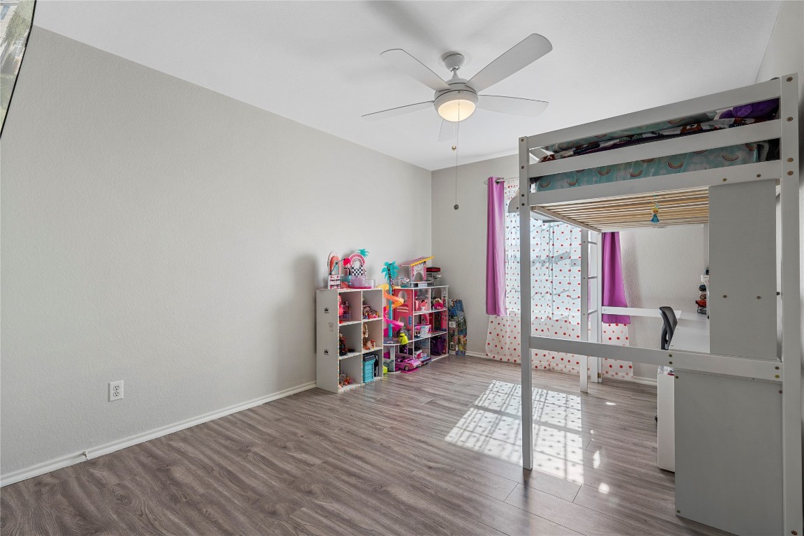 202 Rinehardt Street Hutto, TX 78634 - Photo 26 of 31 an empty room with wooden floor and furniture