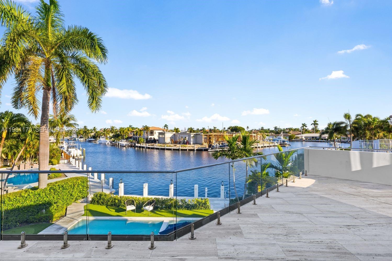 2300 Northeast 34th Court Lighthouse Point, FL 33064 - Photo 26 of 50 a small swimming pool with outdoor seating and yard