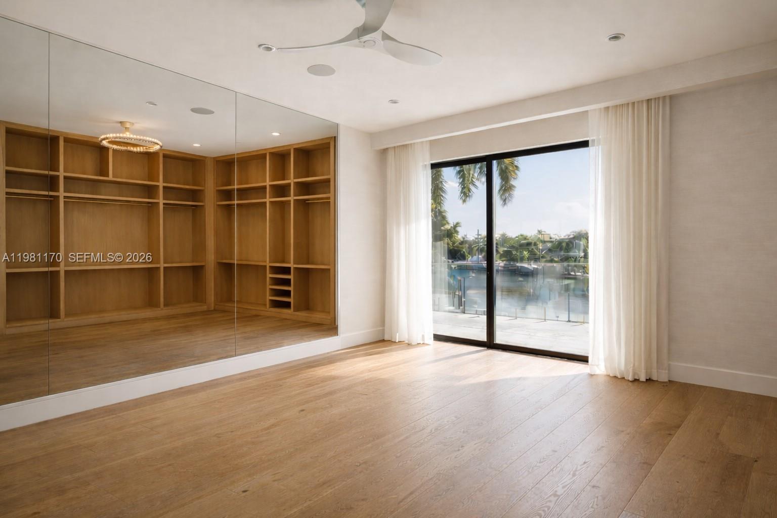 2300 Northeast 34th Court Lighthouse Point, FL 33064 - Photo 36 of 50 a view of an empty room with a window and wooden floor