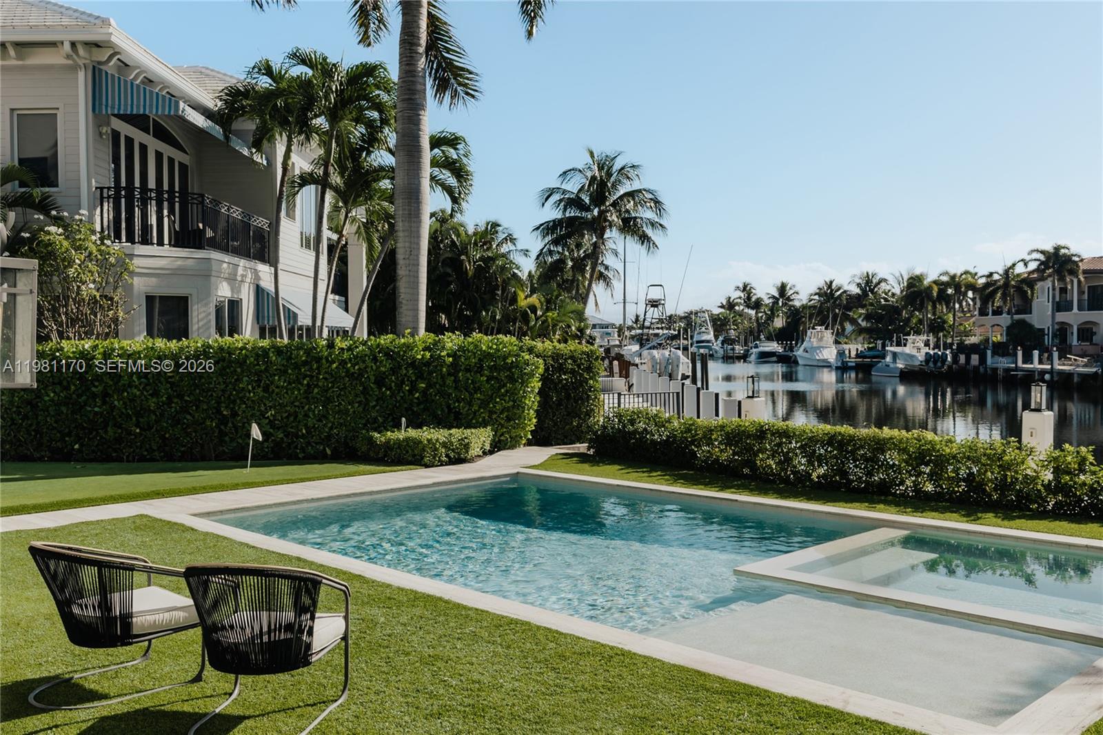 2300 Northeast 34th Court Lighthouse Point, FL 33064 - Photo 44 of 50 a view of a swimming pool with a patio and plants