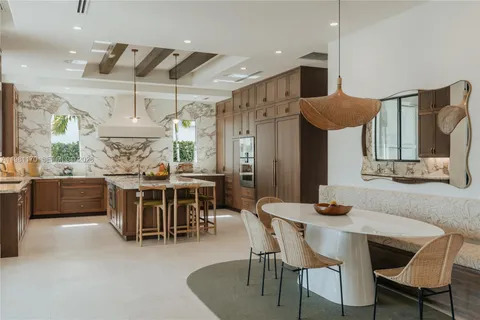 a dining room with furniture and a large window