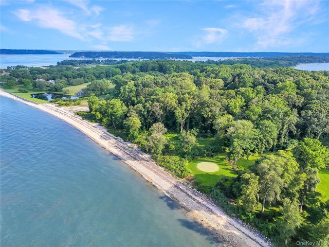 a view of a green field with an ocean view