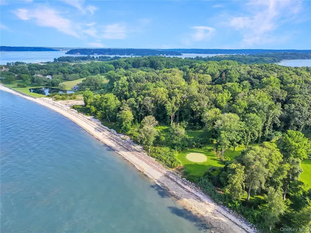 a view of a green field with an ocean view
