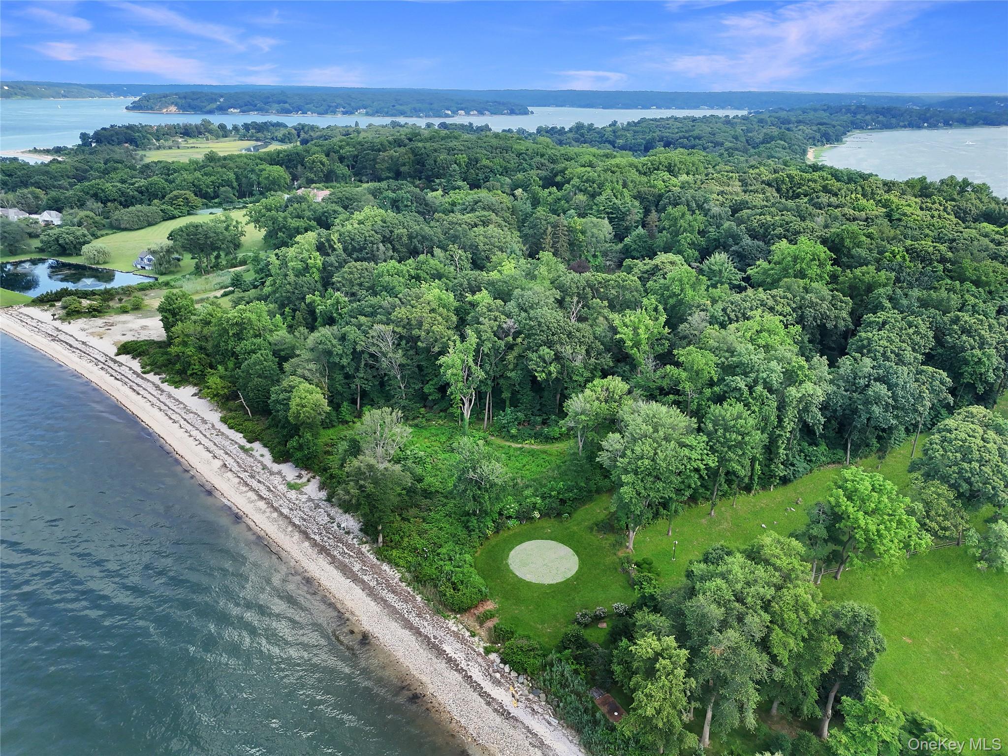 144 Centre Island Road Centre Island, NY 11771 - Photo 7 of 12 a view of a lush green forest with a building in the back