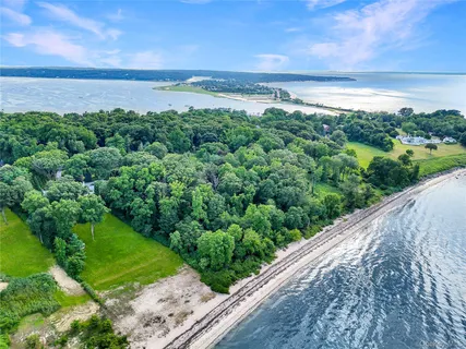 a view of a green field with an ocean
