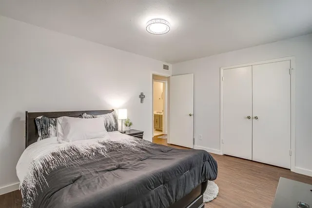 a bedroom with a bed and wooden floor