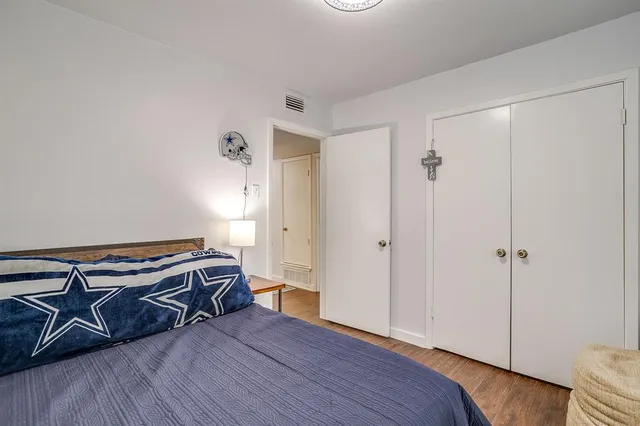 a view of an empty room and wooden floor