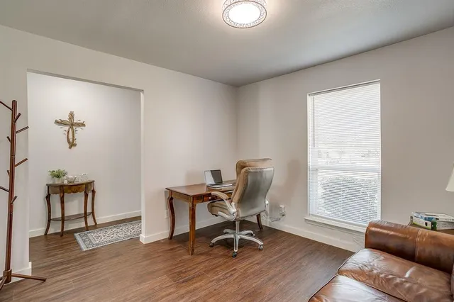 a work room with furniture and wooden floor