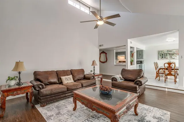 a living room with furniture a rug and a chandelier