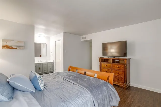 a bedroom with a bed and a flat screen tv