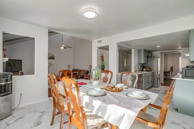 a dining room with furniture and a flat screen tv