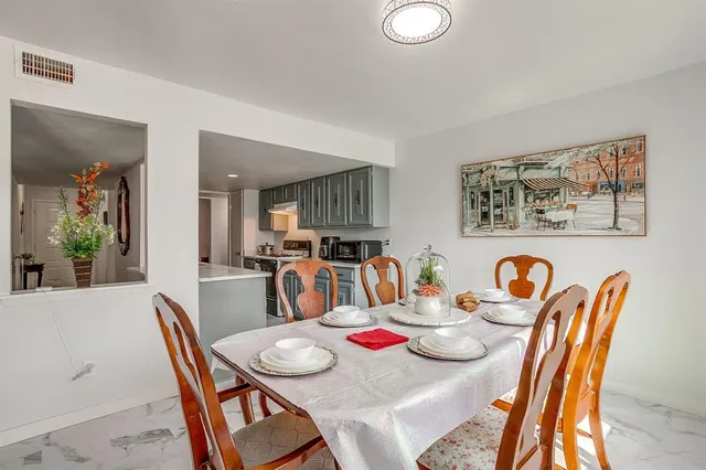 a dining room with furniture and wooden floor