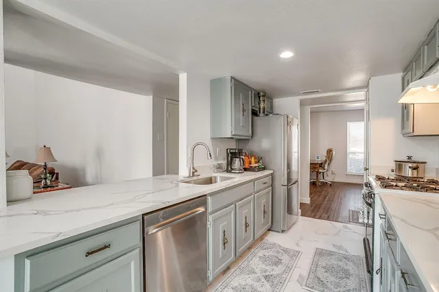 a kitchen with a sink stove and cabinets