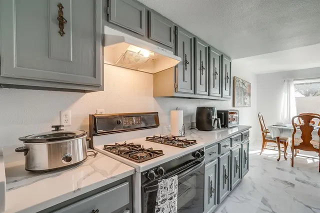 a kitchen with a stove and a refrigerator
