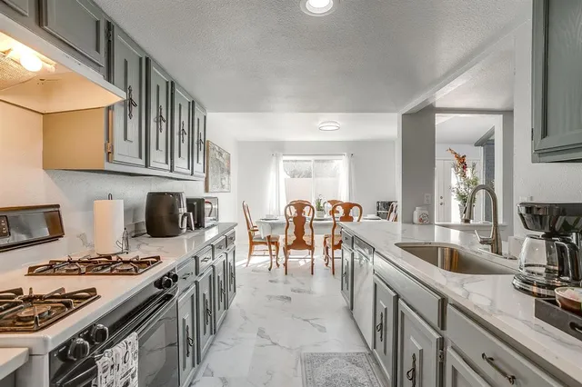 a kitchen with stove and cabinets