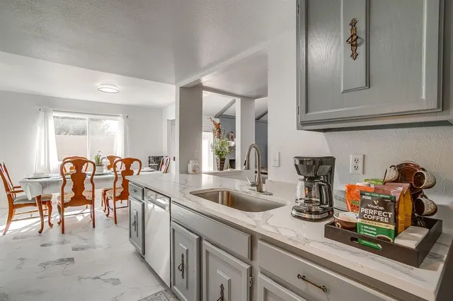 a kitchen with lots of appliances a sink and a cabinets