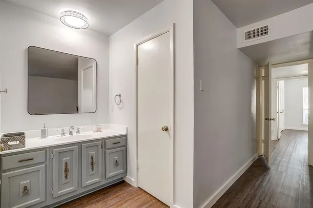 a spacious bathroom with a double vanity sink and a mirror