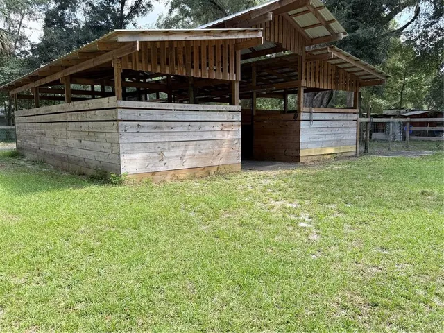 a view of a backyard with sitting area