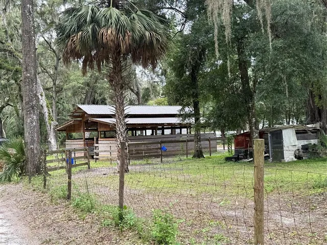 a view of a house with backyard porch and sitting area