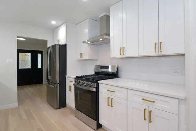 a kitchen with cabinets and stainless steel appliances