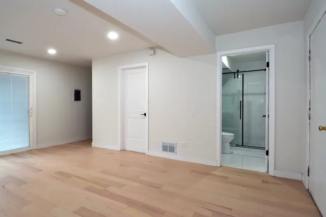 a view of an empty room with wooden floor