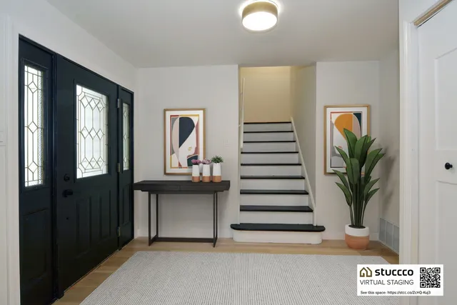 a view of hallway with livingroom and stairs
