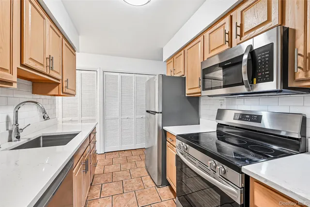 a kitchen with stainless steel appliances a sink and cabinets