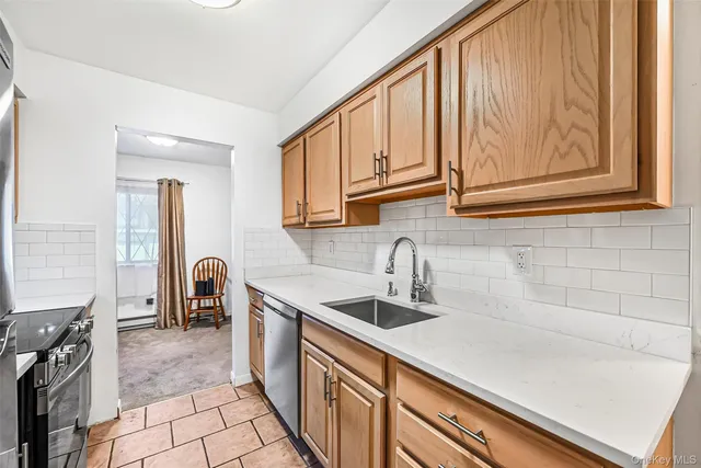 a kitchen with granite countertop a refrigerator and a sink