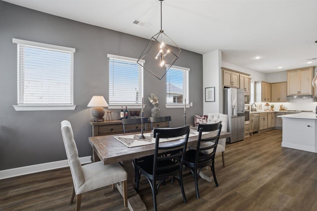 1632 Cotton Road Van Alstyne, TX 75495 - Photo 13 of 40 a view of a dining room with furniture and wooden floor