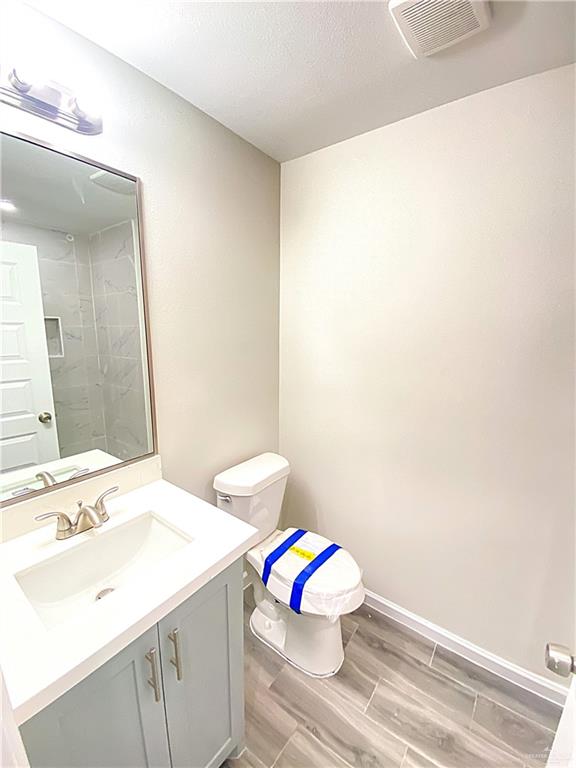 5048 McKenzie Road Brownsville, TX 78521 - Photo 11 of 11 a bathroom with a sink mirror vanity and toilet