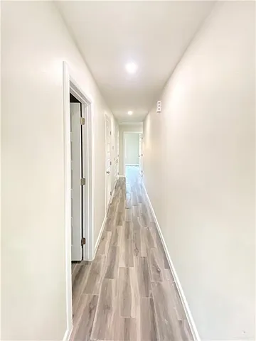 a view of a hallway with wooden floor