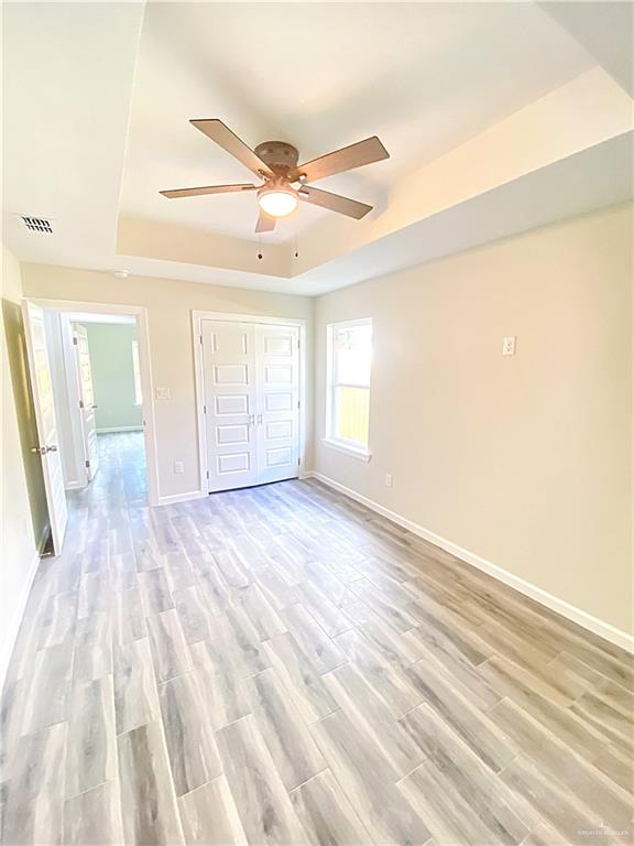 5048 McKenzie Road Brownsville, TX 78521 - Photo 5 of 11 a view of an empty room with wooden floor and a window